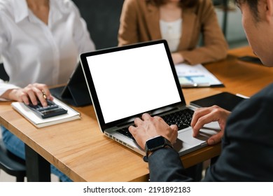 People using and looking at mockup laptop computer on wooden table together on office desk with clipping path tablet - Shutterstock ID 2191892183