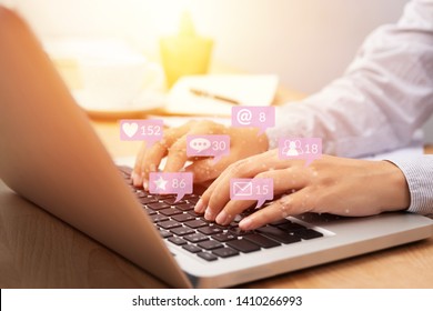people using notebook computer laptop for social media interactions with notification icons from friend in social network with like, message, email, mention and star above smartphone screen. internet  - Shutterstock ID 1410266993