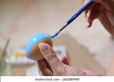 people using paintbrush blue watercolor painting on easter egg design custom pattern handicraft for celebration - Shutterstock ID 1642889989
