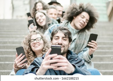People using smart mobile phones app. Students addiction to new technology trends. Happy friends sitting on the staircase. Concept of youth, social and friendship - Image