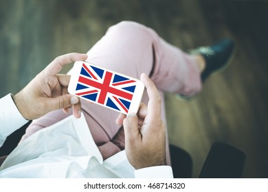 People using smart phone and showing on the screen the flag of UNITED KINGDOM - Shutterstock ID 468714320