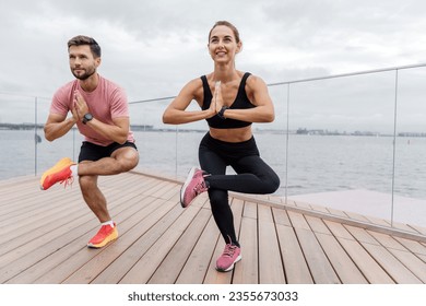 People using smart watches for fitness, sportswear and running shoes.   Athletes couple training plank in sportswear.  Motivation friends doing fitness work out together. - Powered by Shutterstock