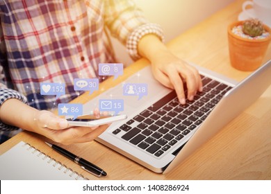 people using smartphone for social media interactions with notification icons from friend in social network with like, message, email, mention and star above smartphone screen. internet marketing - Shutterstock ID 1408286924
