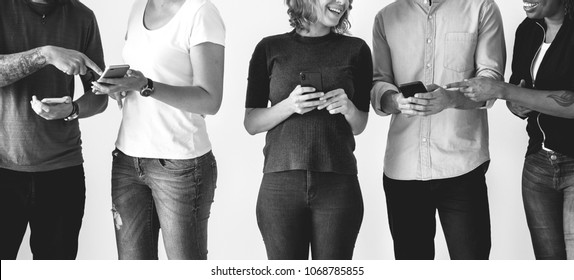 People Using Smartphones In A Row