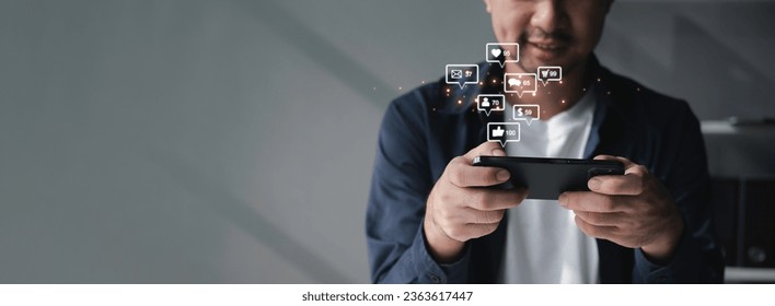 People using social media and digital online marketing concepts on mobile phones with icons such as notifications, messages, comments on the smartphone screen. - Shutterstock ID 2363617447