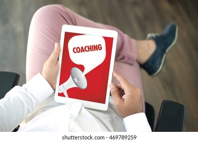 People using tablet pc and COACHING announcement concept on screen