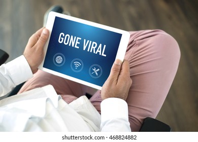 People using tablet pc and GONE VIRAL concept on screen