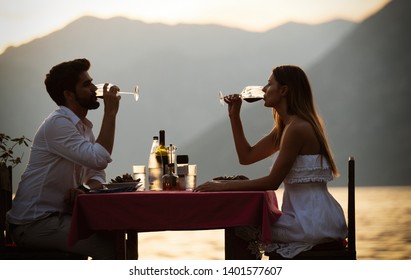 People, Vacation, Love And Romance Concept. Young Couple Enjoying A Romantic Dinner On Beach.