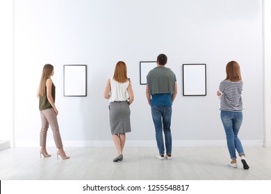 People Viewing Exposition In Modern Art Gallery