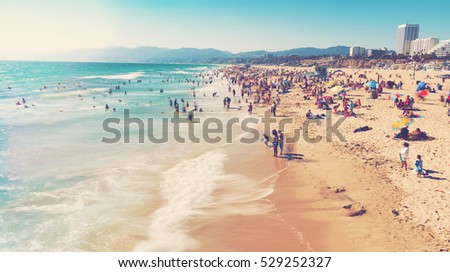 People visit the beach in Santa Monica, California