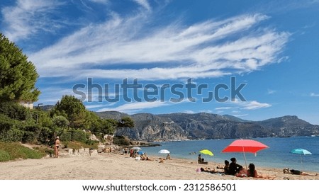 People visit beautiful summer sandy beach in France.