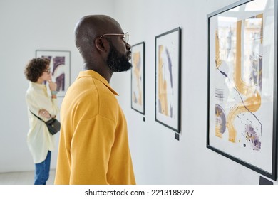 People visiting art exhibition at gallery