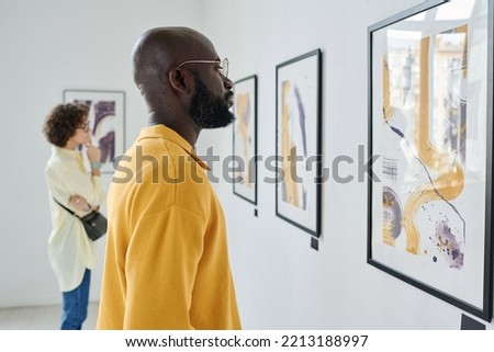 People visiting art exhibition at gallery