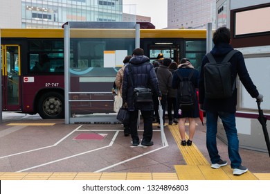 People Wait In Line At Bus Stop Before Take The City Bus To Their Destination.