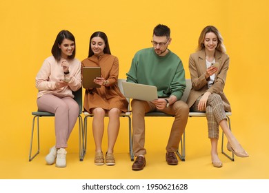 People Waiting For Job Interview On Yellow Background