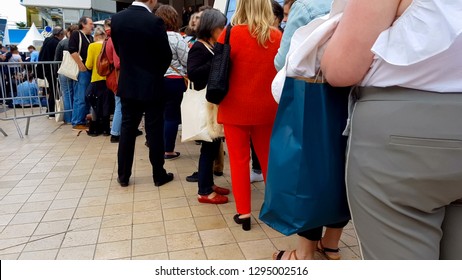 People waiting in queue near Cannes film festival entrance, cinematography event