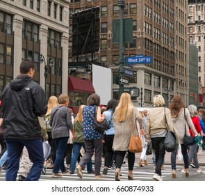 People Walk Across A Busy Manhattan Crosswalk In New York City During Rush Hour Evening Commute Travel To Work And Home