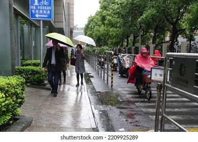 People Walk Along A City Centre Street During A Rain Storm On April 29, 2019 In Shanghai, China.