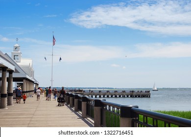 People walk along the pier on a sunny summer day. Joe Riley Waterfront Park. Charleston, SC / USA - July 21 2018
