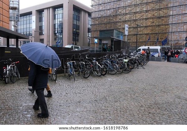 People walk during a
heavy rainfall outside of European institutions in Brussels,
Belgium on Dec. 13, 2019