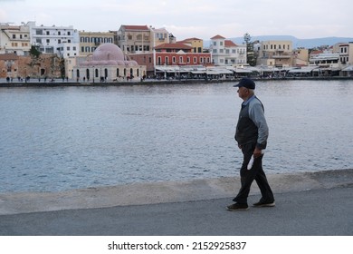People walk in the old Venetian harbor of Chania town on Crete island, Greece on November 14, 2021.