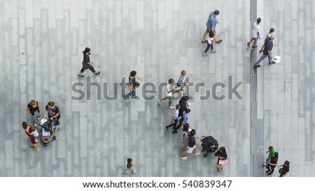 people walk on the pedestrian street walkway with the teenage young man and the group of family with little child. (Aerial urban city photo)