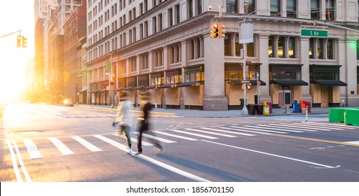 People Walking Across The Empty Street Intersection On Fifth Avenue Past Boarded Up Buildings During The Coronavirus Lockdown In New York City 2020