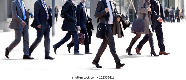 People walking against a light background. Walking businessmen against a background of an urban landscape. - Shutterstock ID 102335416