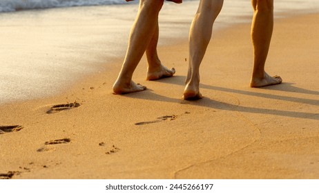 People walking along the sandy beach barefoot - Powered by Shutterstock