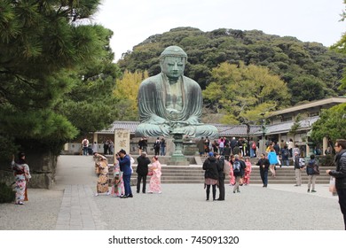 People Walking Around Of Bronze Statue Of Amida Buddha Known As Great Buddha Of Kamakura (Daibutsu), A National Treasure Of Japan, In Kotoku-in Temple, Kamakura, Japan, On November 8th, 2016