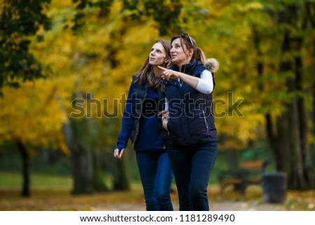 Similar – happy twin sisters stand on a bridge and look up