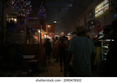 People Walking In Corridor Of Smoke In The Market Of Oaxaca, Mexico. December 2, 2021