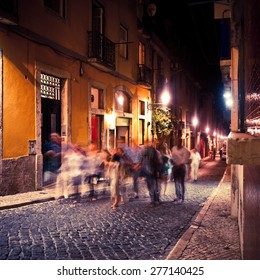 People Walking In Lisbon At Night