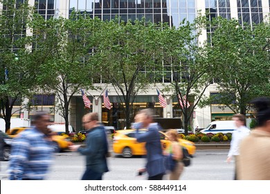 People walking in motion blur busy Manhattan street at rush hour