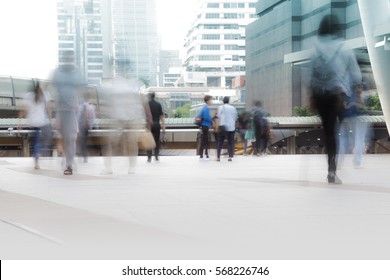 People Walking In Motion Blur In The City