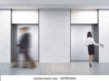 People Are Walking In Office. Two Closed Elevators With Buttons In Corridor With Concrete Walls. Concept Of Office Center Day. 3d Rendering. Mock Up. 