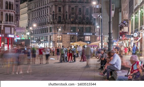 People Walking In The Old City Center Of Vienna In Stephansplatz Night Timelapse. Shops And Restaurants Around, Crowded Place