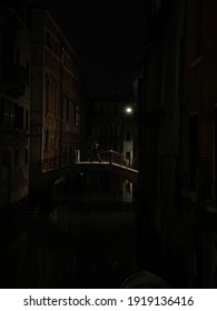 People Walking On A Bridge In Venice By Night, Italy