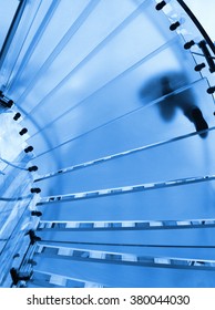 People Walking On The Glass Spiral Stairs.