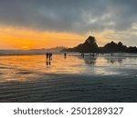 People walking on Long Beach near Tofino BC Canada during a beautiful sunset | Original Photo NO edits