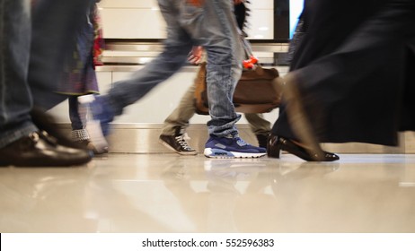 People Walking On Moving Staircase With Luggage In The International Airport, Close Up Shot Of Legs And Shoes