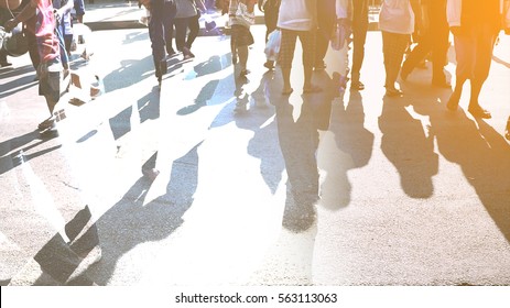 People Walking On The Pedestrian Crossing In Motion Blur.