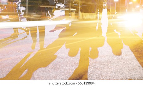 People Walking On The Pedestrian Crossing In Motion Blur.