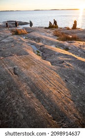 People Walking On A Rocky Shore In Bjorno Nature Reserve At Baltic Sea. Beautiful Natural Scandinavian Landscape On Sunny Late Autumn Or Winter Day In Sweden, Stockholm Archipelago 2021.12.17