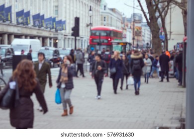 People Walking On The Side Walk In A Street In London.