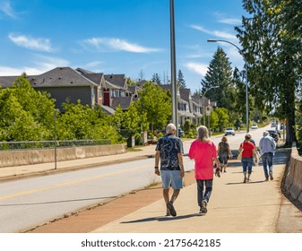 People Walking On Street Walkway On A Sunny Summer Day. Urban Neighborhood In Summer Day. Elderly People On A Walk. Street Photo, Selective Focus-June 24,2022-Vancouver BC Canada