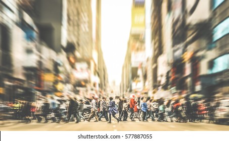 People walking on zebra crossing on 7th avenue in Manhattan - Crowded streets of New York City during rush hour in urban business area - Retro desaurated contrast filter with soft sharpness and focus - Shutterstock ID 577887055