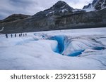 People walking one behind the other to avoid crevasses. Athabasca Glacier from Columbia Icefield. Alberta, Canada
September 2021