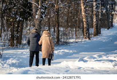 people walking in the park in winter, rear view - Powered by Shutterstock