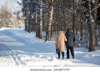 people walking in the park in winter, rear view - Powered by Shutterstock